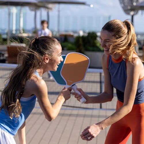 Guests playing paddle court games onboard Celebrity Cruises