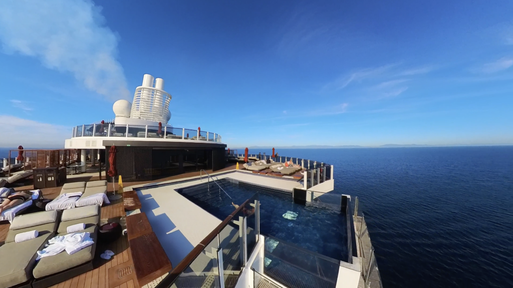 t: Latitude Rewards members relaxing on the exclusive VIP deck aboard Norwegian Cruise Line, with private sun loungers and ocean views