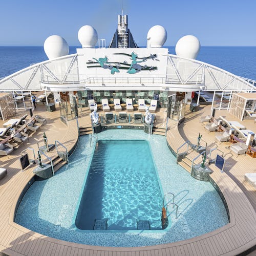 Guests relaxing on the exclusive MSC Yacht Club sun deck, featuring private pool, whirlpool, and panoramic ocean views.