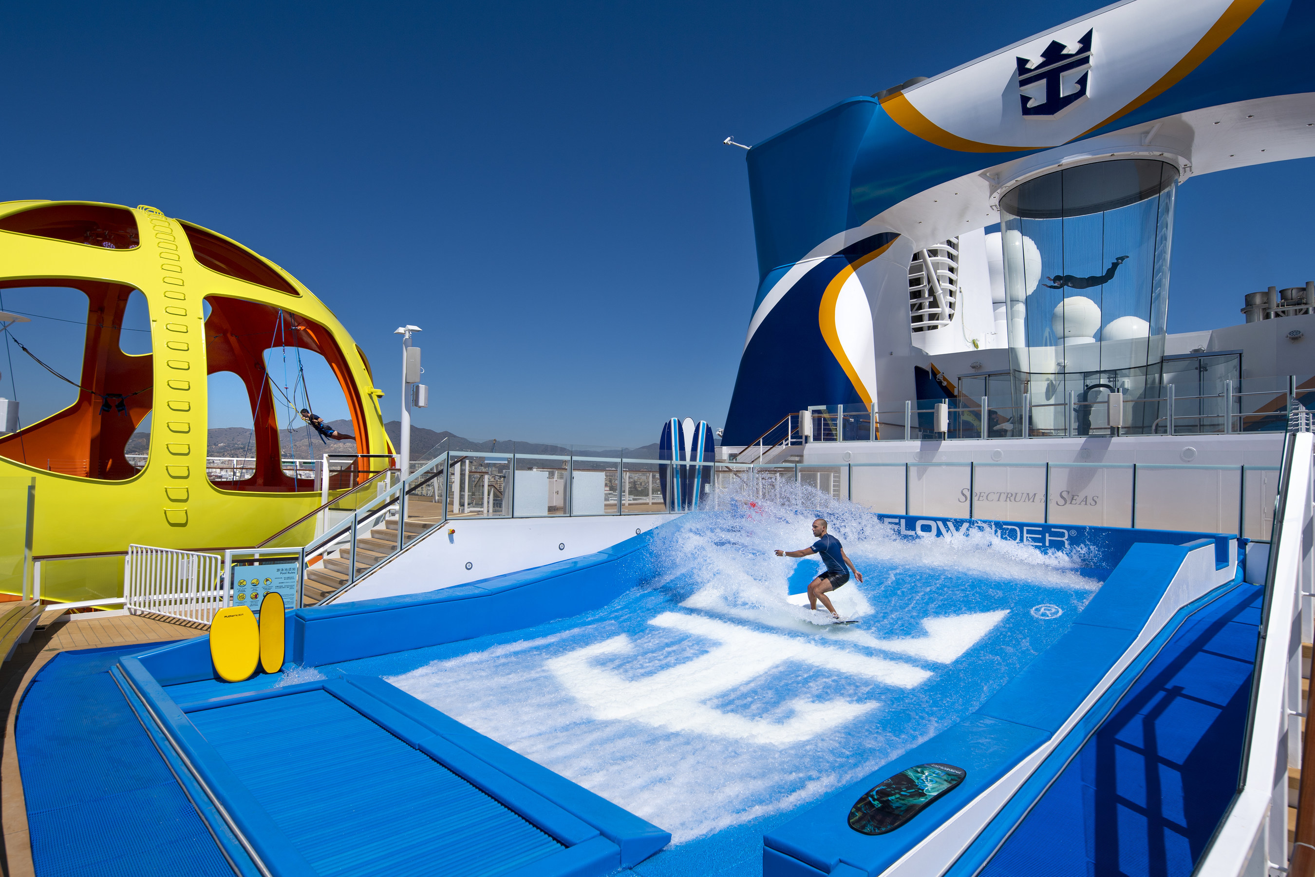 Guest surfing on the FlowRider® aboard Royal Caribbean, enjoying thrilling onboard adventures at sea