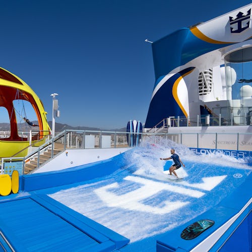 Guest surfing on the FlowRider® aboard Royal Caribbean, enjoying thrilling onboard adventures at sea