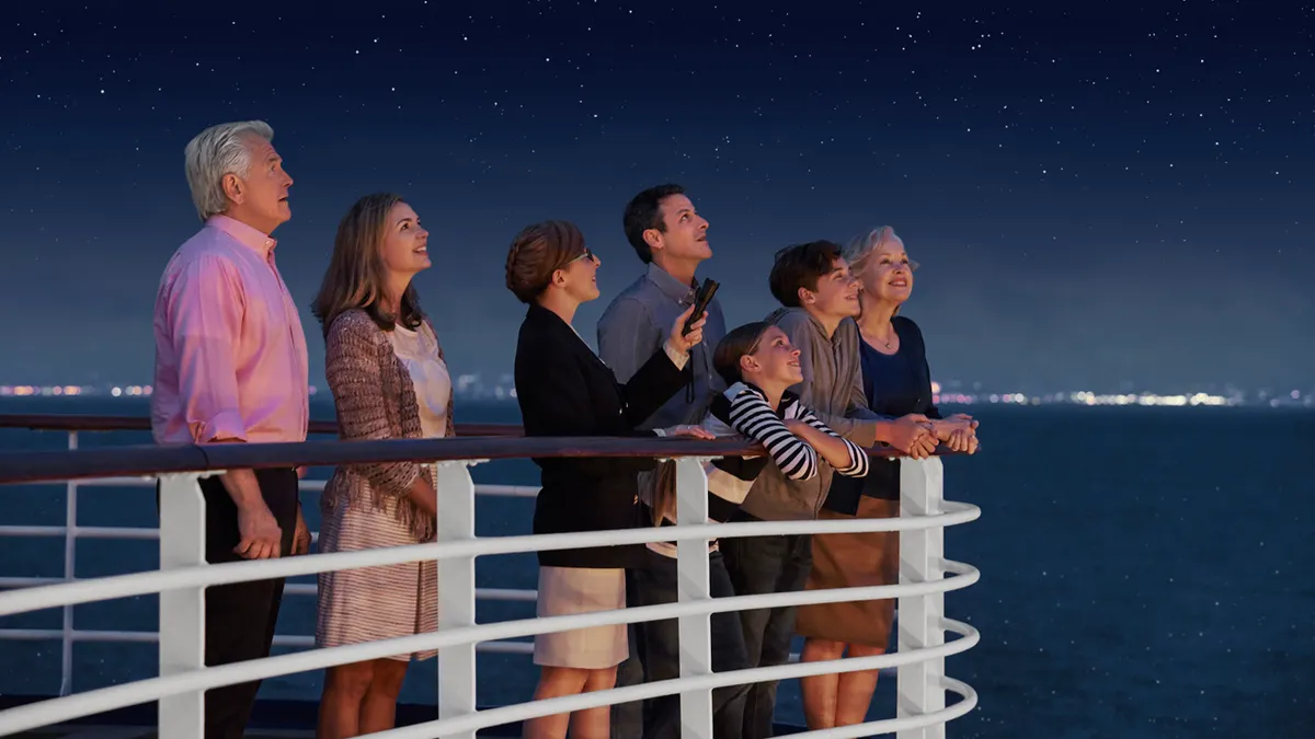 Guests enjoying stargazing and Discovery™ activities onboard Princess Cruises under a night sky