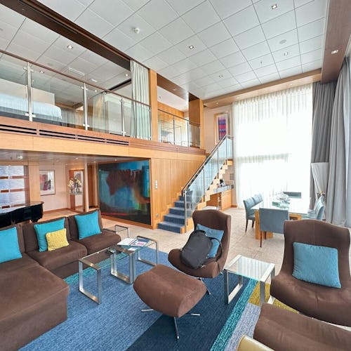Spacious Royal Suite aboard Royal Caribbean, featuring elegant furnishings, panoramic ocean views, and premium amenities.