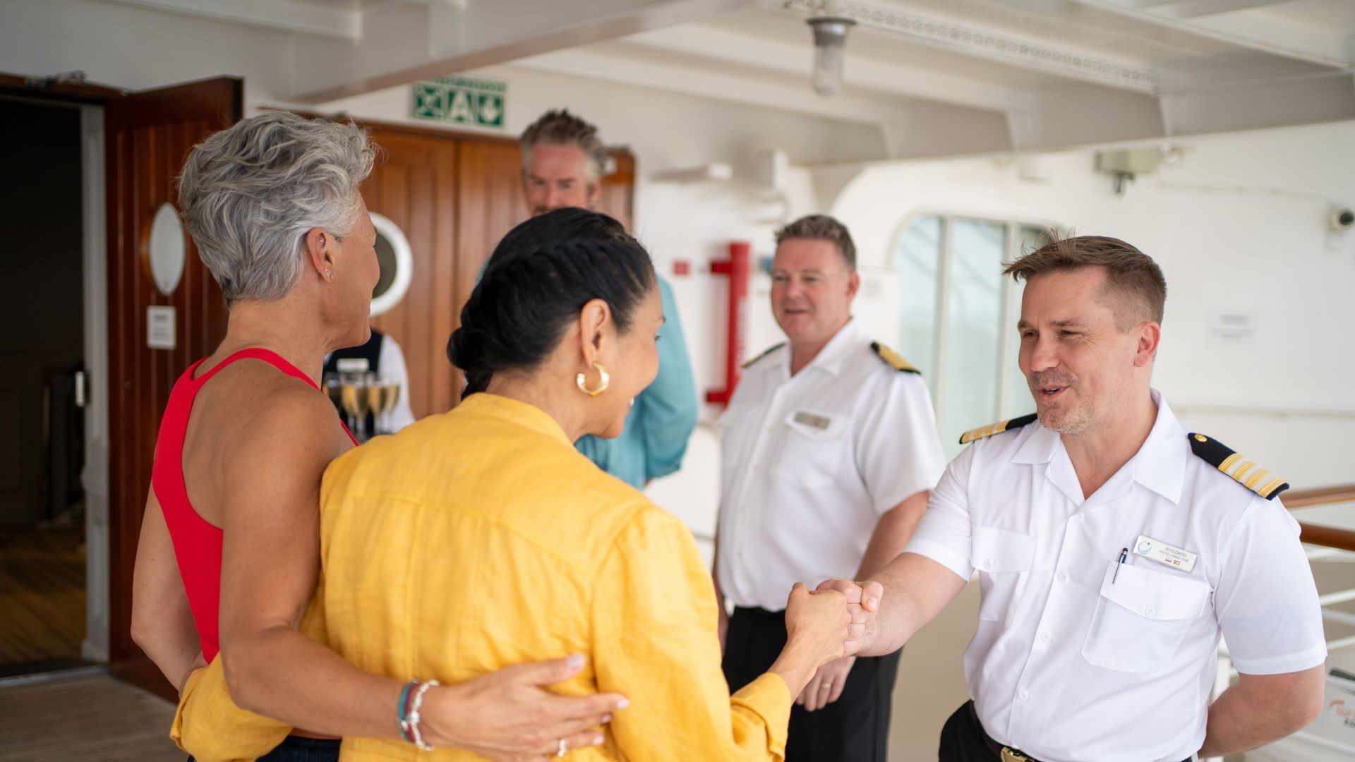 Azamara Captain warmly welcoming guests onboard, highlighting the line’s personalised and intimate service style.