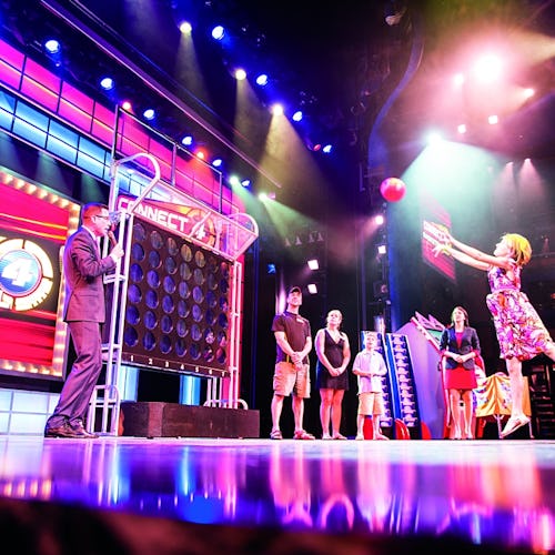 Guests enjoying a live comedy show aboard Carnival Cruise Line, with vibrant nightlife and entertainment options