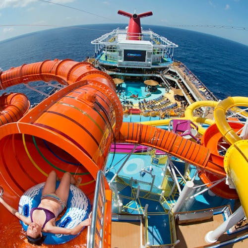 Guests splashing down waterslides and relaxing by the pool on a Carnival Cruise, enjoying sun-soaked fun at sea.