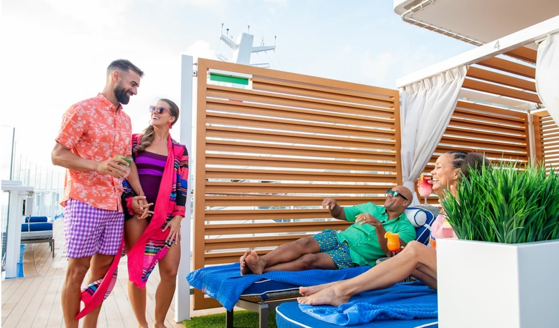 Guests unwinding in a quiet deck area aboard Carnival Cruise Line, with loungers, ocean views, and a laid-back atmosphere