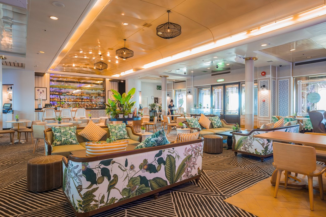 Elegant lounge aboard Ambassador Cruise Line, featuring comfortable seating, live music, and a relaxed adult-only atmosphere.