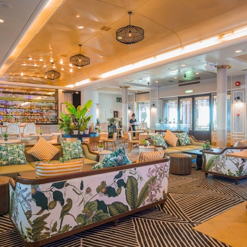 Elegant lounge aboard Ambassador Cruise Line, featuring comfortable seating, live music, and a relaxed adult-only atmosphere.