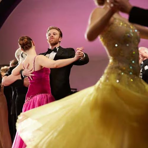 Elegant couple ballroom dancing in the grand ballroom aboard Cunard, enjoying refined evenings and timeless traditions at sea.